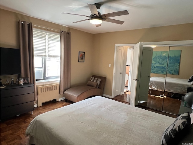 bedroom featuring dark parquet flooring, radiator, and ceiling fan