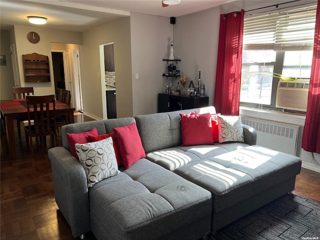 living room with cooling unit, dark parquet flooring, and radiator heating unit