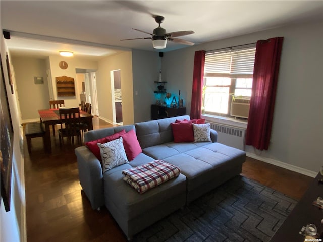 living room featuring radiator heating unit, dark hardwood / wood-style flooring, and ceiling fan