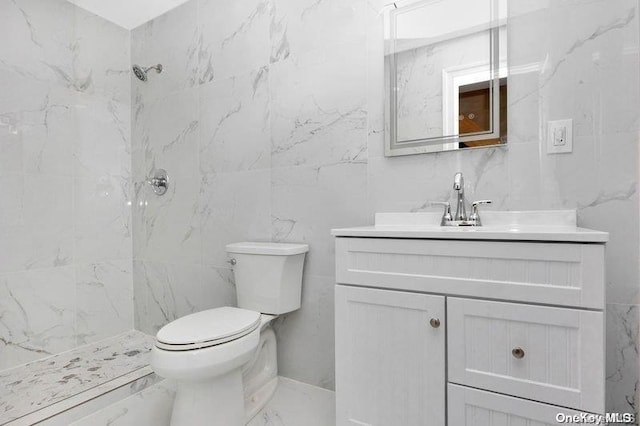 bathroom with vanity, tile walls, and tiled shower