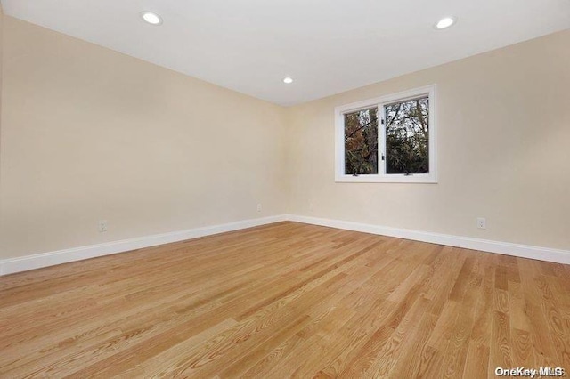 spare room featuring light hardwood / wood-style floors