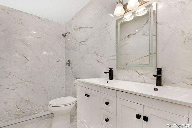 bathroom with toilet, vanity, tile walls, and tiled shower