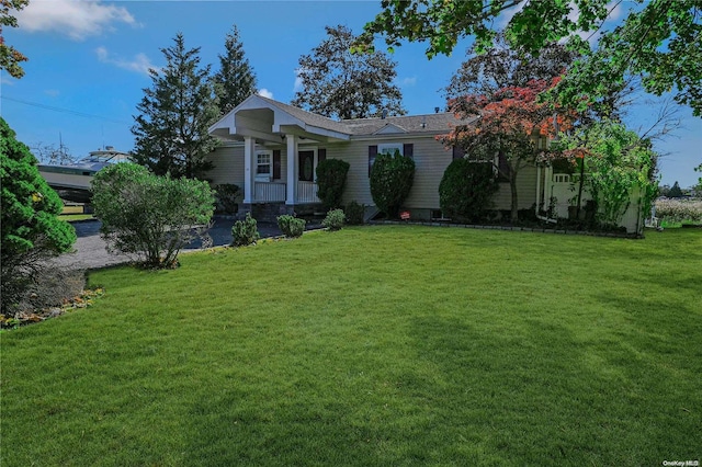 view of front of home featuring a front yard and covered porch