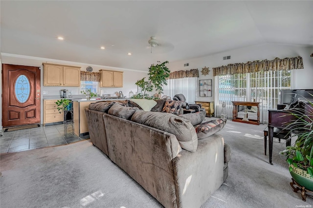 living room with light carpet, ceiling fan, a healthy amount of sunlight, and lofted ceiling