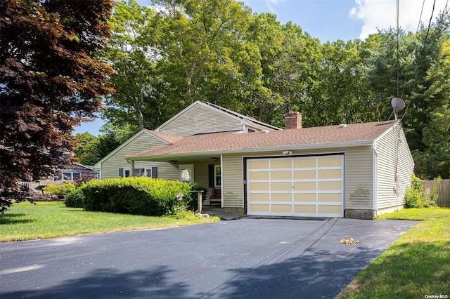 view of front of property with a garage and a front lawn