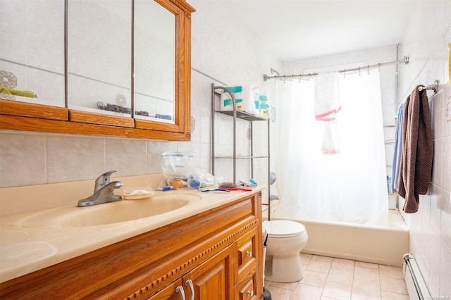 full bathroom with tile patterned flooring, a baseboard heating unit, toilet, vanity, and tile walls