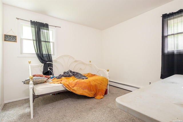 carpeted bedroom with a baseboard radiator