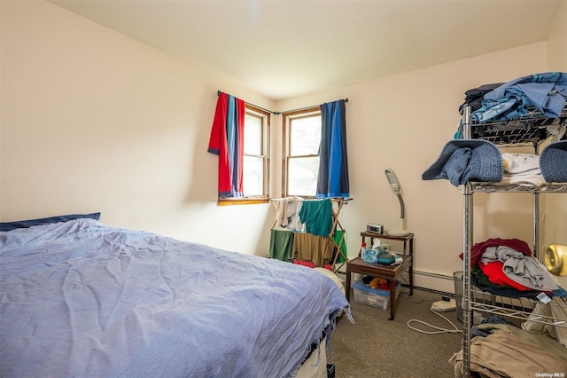 carpeted bedroom with a baseboard heating unit