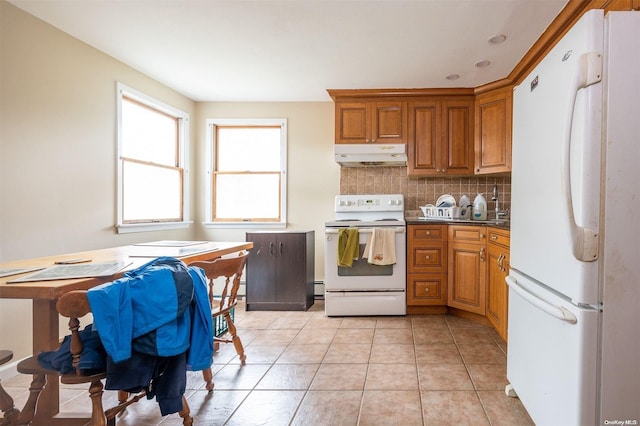 kitchen with white appliances, tasteful backsplash, and light tile patterned flooring