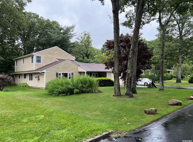 view of side of property featuring a lawn