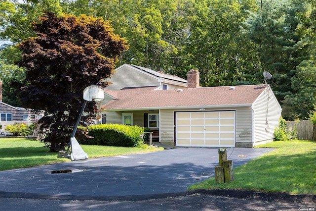 view of front of house featuring a garage and a front lawn