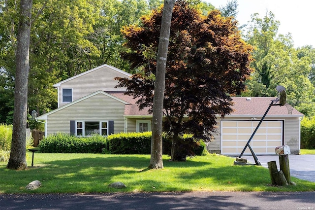 view of front of house with a garage and a front lawn