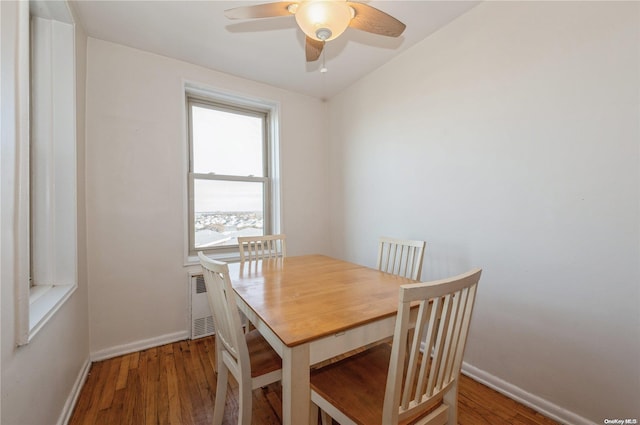 dining room featuring radiator, wood-type flooring, and ceiling fan