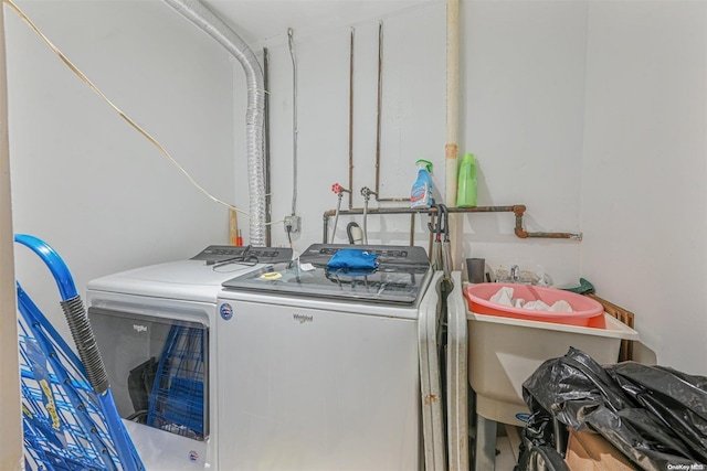 clothes washing area with washer and dryer