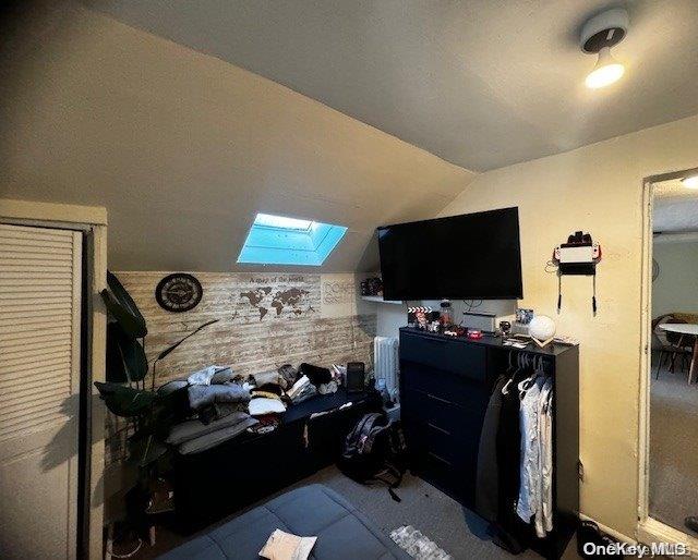 bedroom with vaulted ceiling with skylight