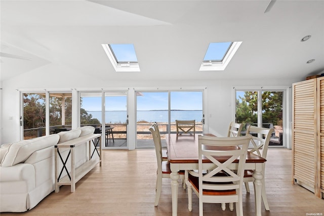 21 E Shore Dr, Southampton, NY 11968 - dining room featuring light hardwood / wood-style floors, lofted ceiling with skylight, and a water view