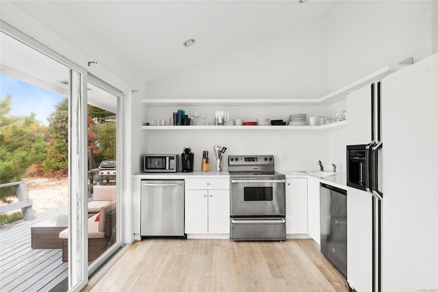 21 E Shore Dr, Southampton, NY 11968 - kitchen featuring white cabinets, stainless steel appliances, vaulted ceiling, and light wood-type flooring