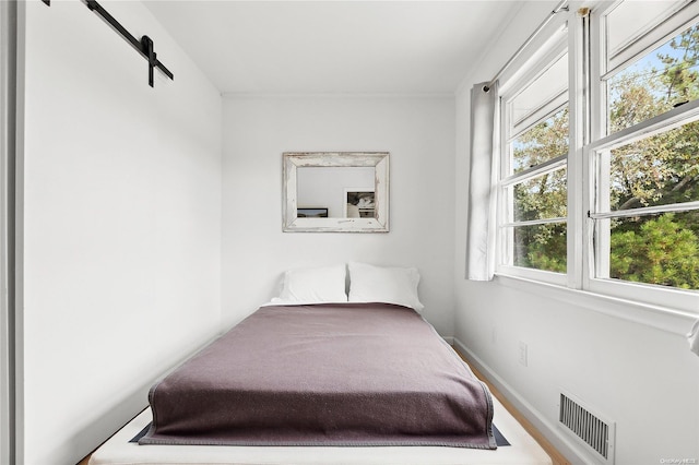 21 E Shore Dr, Southampton, NY 11968 - bedroom featuring a barn door