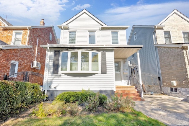 view of front of property with a wall mounted air conditioner