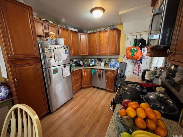 kitchen with light wood-type flooring and stainless steel appliances