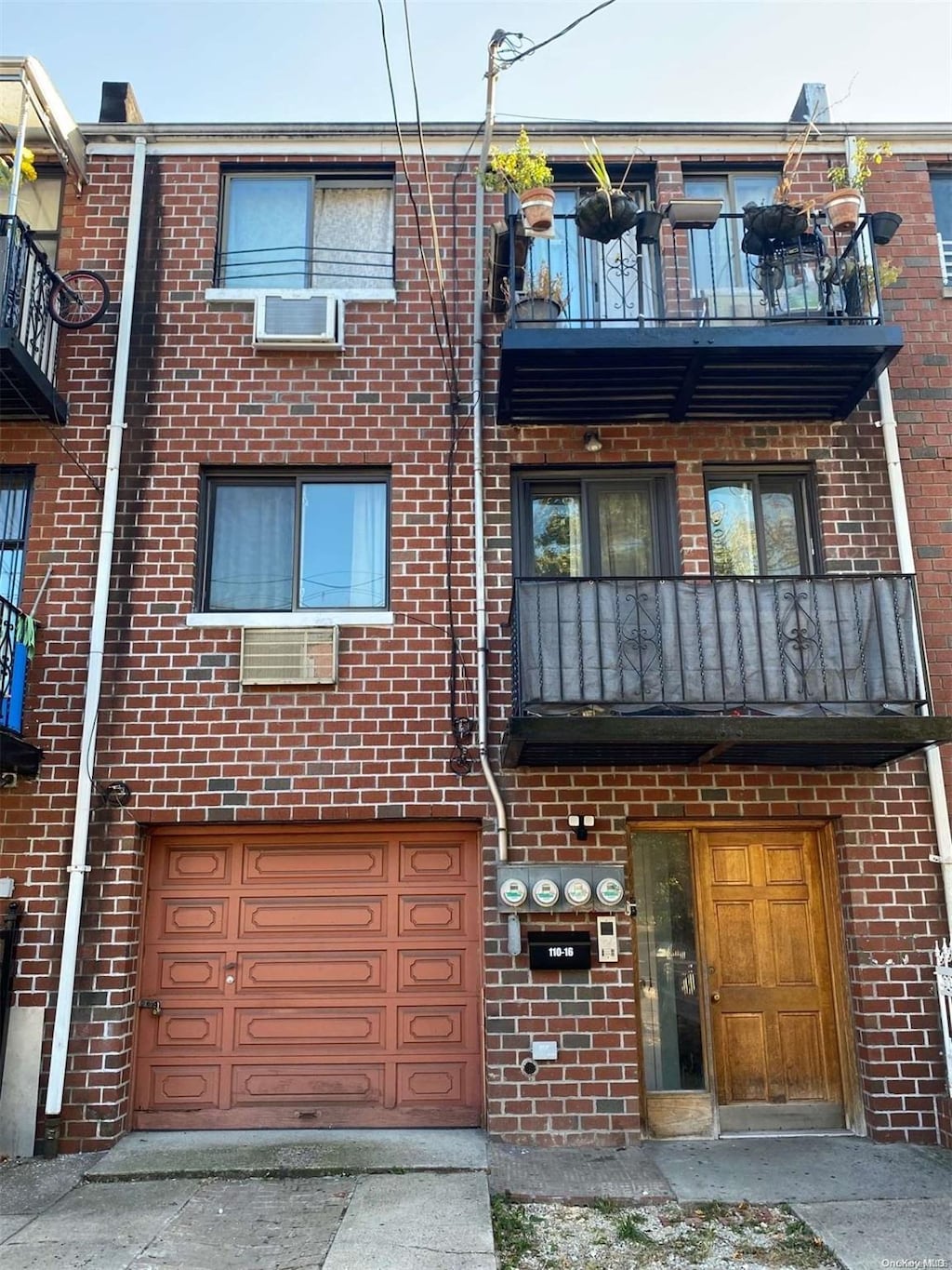 multi unit property featuring a balcony and a garage