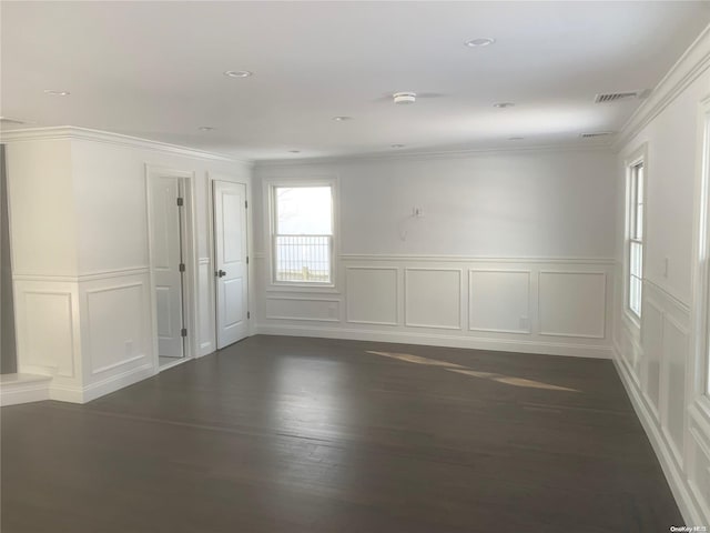 spare room with ornamental molding and dark wood-type flooring