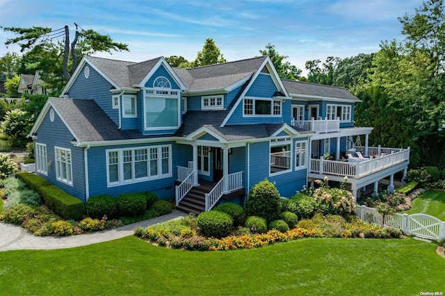 view of front of house with a front yard and a balcony