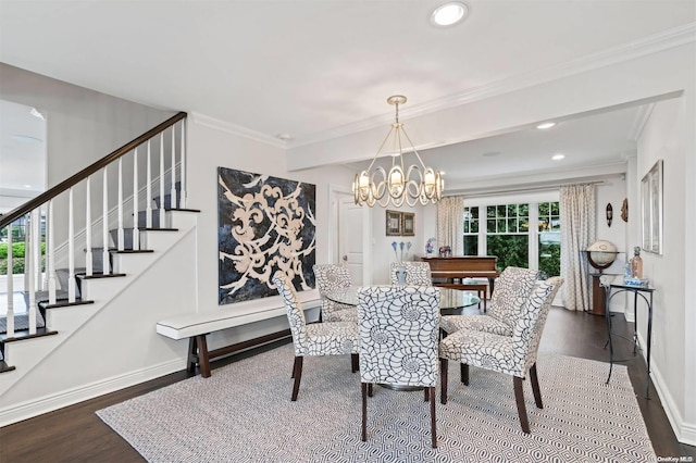 dining area featuring ornamental molding, wood-type flooring, and a notable chandelier