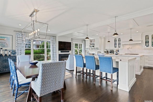 dining area featuring dark hardwood / wood-style floors and ornamental molding