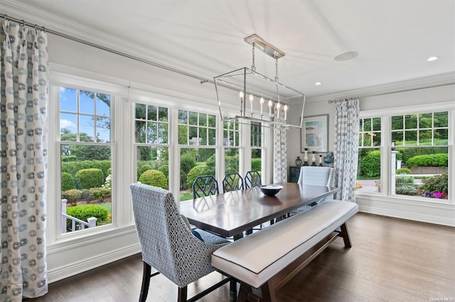 sunroom featuring plenty of natural light and an inviting chandelier