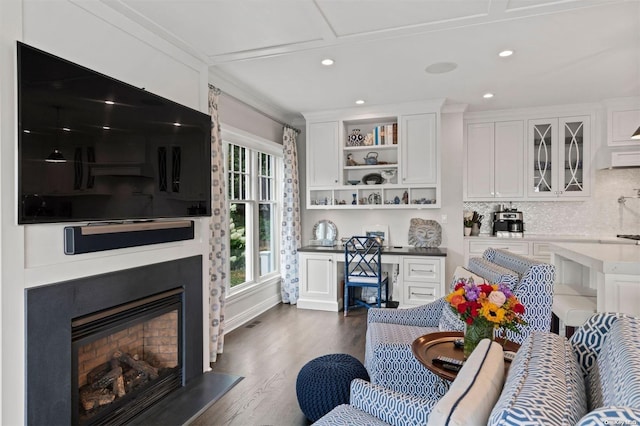 living room featuring ornamental molding and dark wood-type flooring