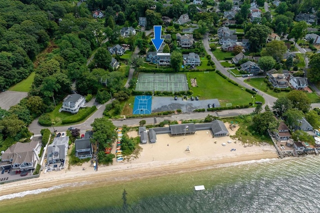 aerial view with a water view and a beach view