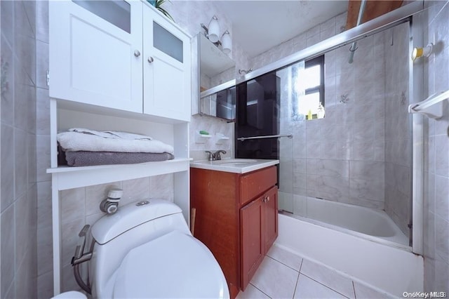 full bathroom featuring vanity, tile patterned floors, enclosed tub / shower combo, tile walls, and tasteful backsplash