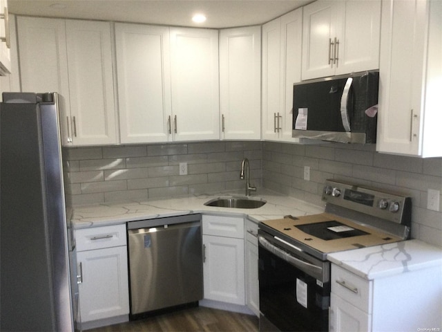 kitchen featuring white cabinetry, sink, dark wood-type flooring, and appliances with stainless steel finishes