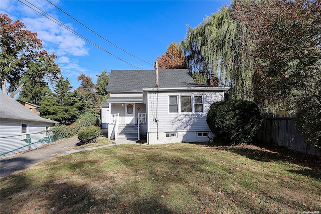 rear view of property with a yard