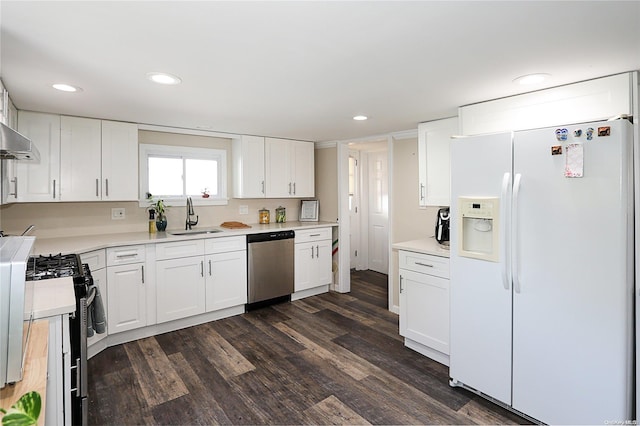 kitchen with dark hardwood / wood-style flooring, white cabinetry, sink, and appliances with stainless steel finishes