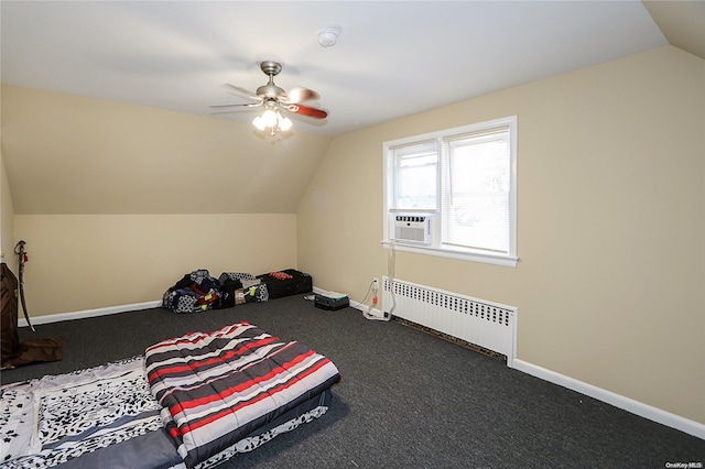 additional living space with dark colored carpet, ceiling fan, lofted ceiling, and radiator