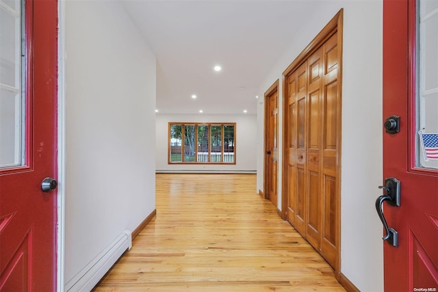 foyer entrance featuring light wood-type flooring and baseboard heating