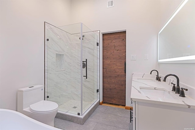 bathroom featuring tile patterned floors, vanity, toilet, and an enclosed shower