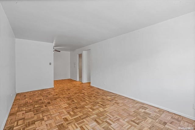 unfurnished room featuring ceiling fan and light parquet floors