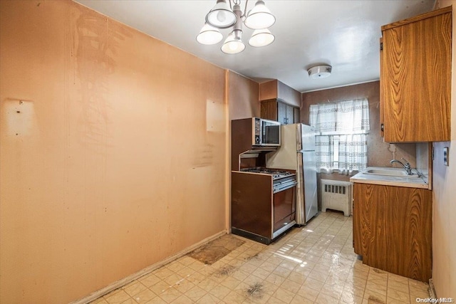 kitchen featuring sink, an inviting chandelier, range, fridge, and radiator heating unit