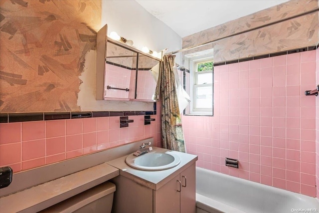 full bathroom with vanity, shower / tub combo with curtain, toilet, tile walls, and tasteful backsplash