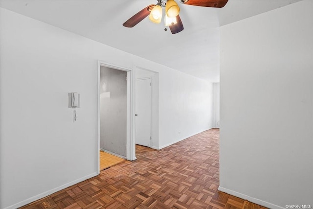 empty room featuring ceiling fan and light parquet floors