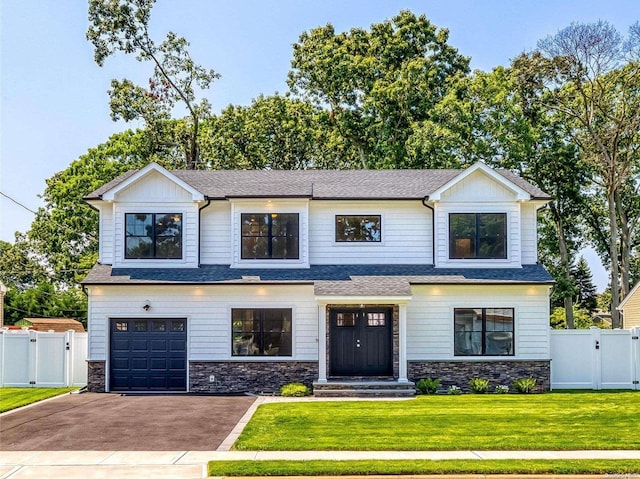 view of front of home featuring a front yard and a garage