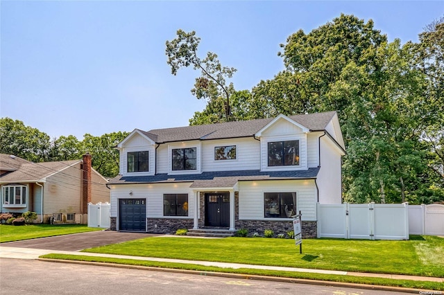 view of front of house with a garage and a front lawn