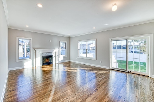 unfurnished living room with hardwood / wood-style floors and ornamental molding