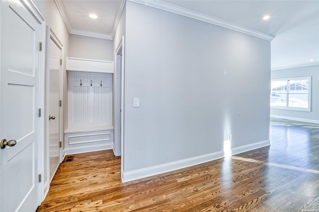 interior space featuring light wood-type flooring and crown molding