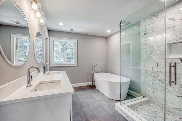 bathroom featuring vanity and separate shower and tub