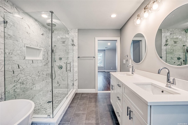 bathroom with tile patterned flooring, vanity, and independent shower and bath