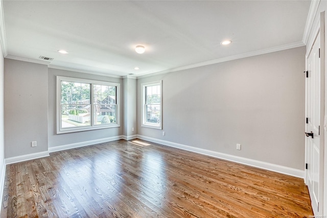 unfurnished room with ornamental molding and hardwood / wood-style flooring